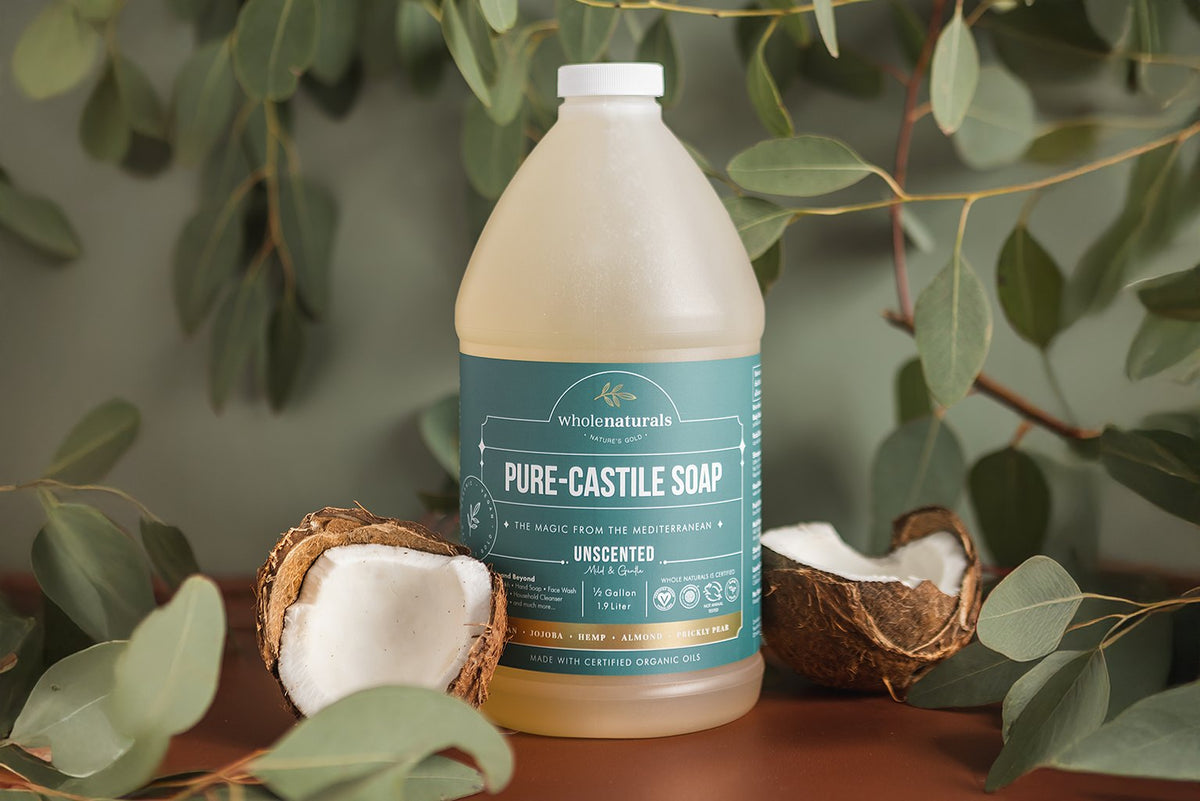 Half gallon bottle of unscented Pure-Castile Soap with coconut halves, showing the certified organic oils it is made from