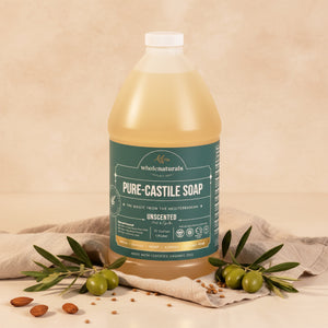 Bottle of Pure-Castile Soap on linen with olive branches, green olives and almonds around it