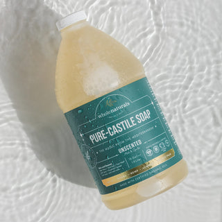 Bottle of Pure-Castile Soap lying in shallow rippling water